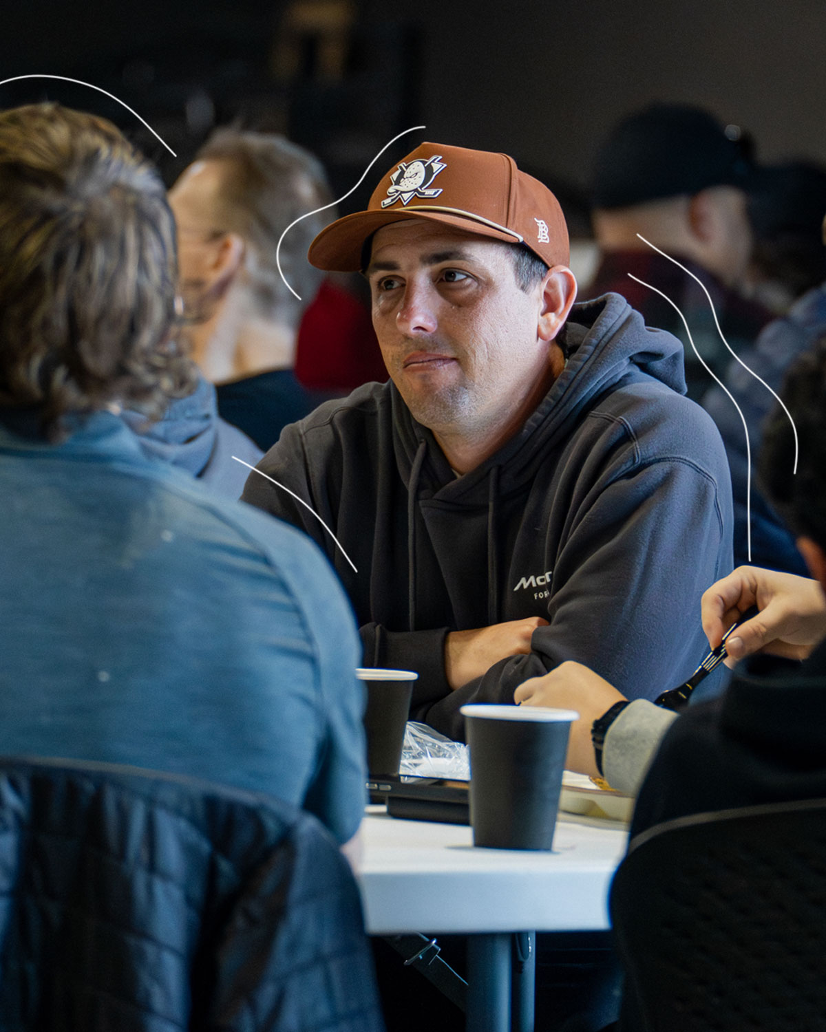 A small group of men talking around a table at Shelter Cove