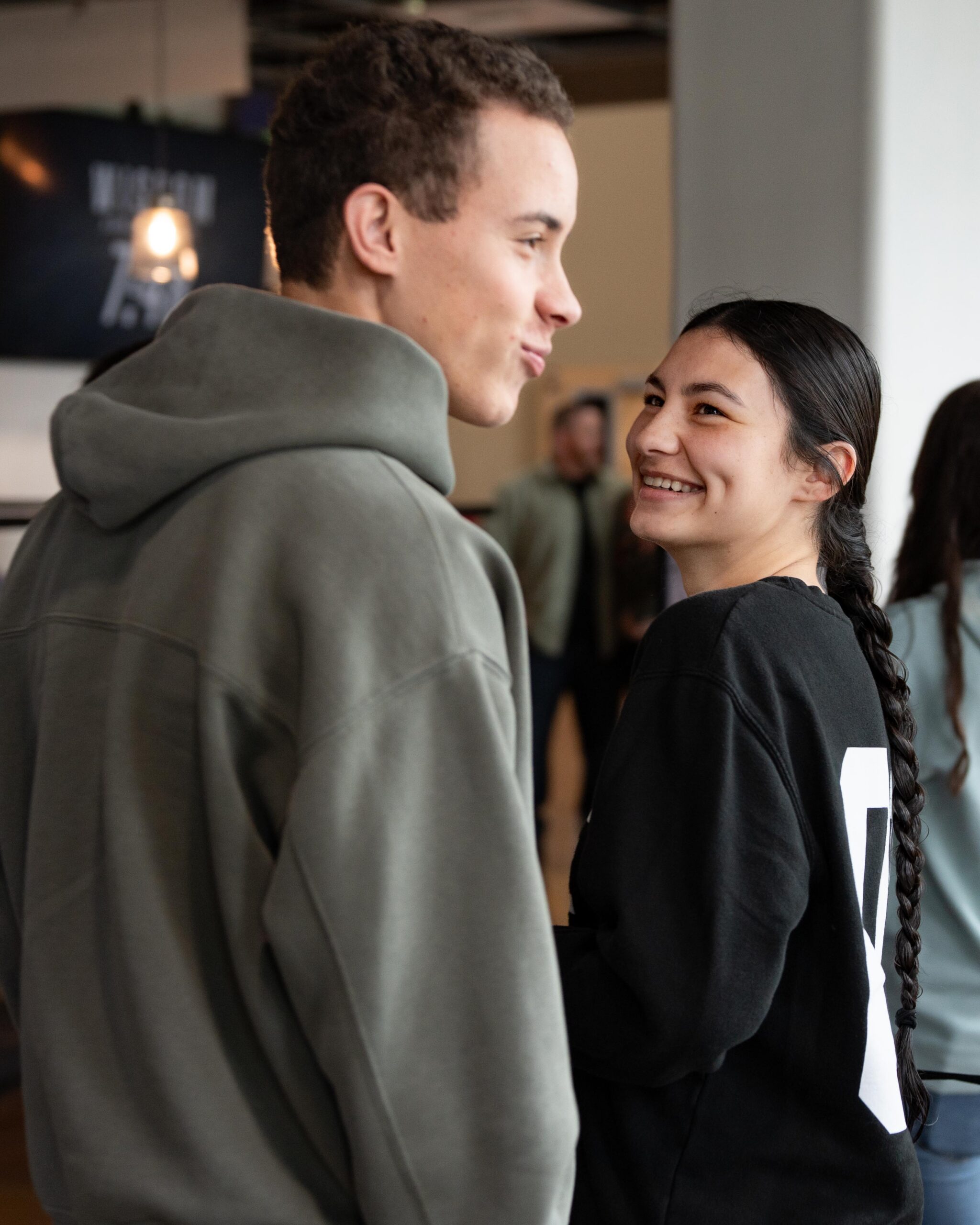 A man and woman smiling and talking together at a Cove Groups event