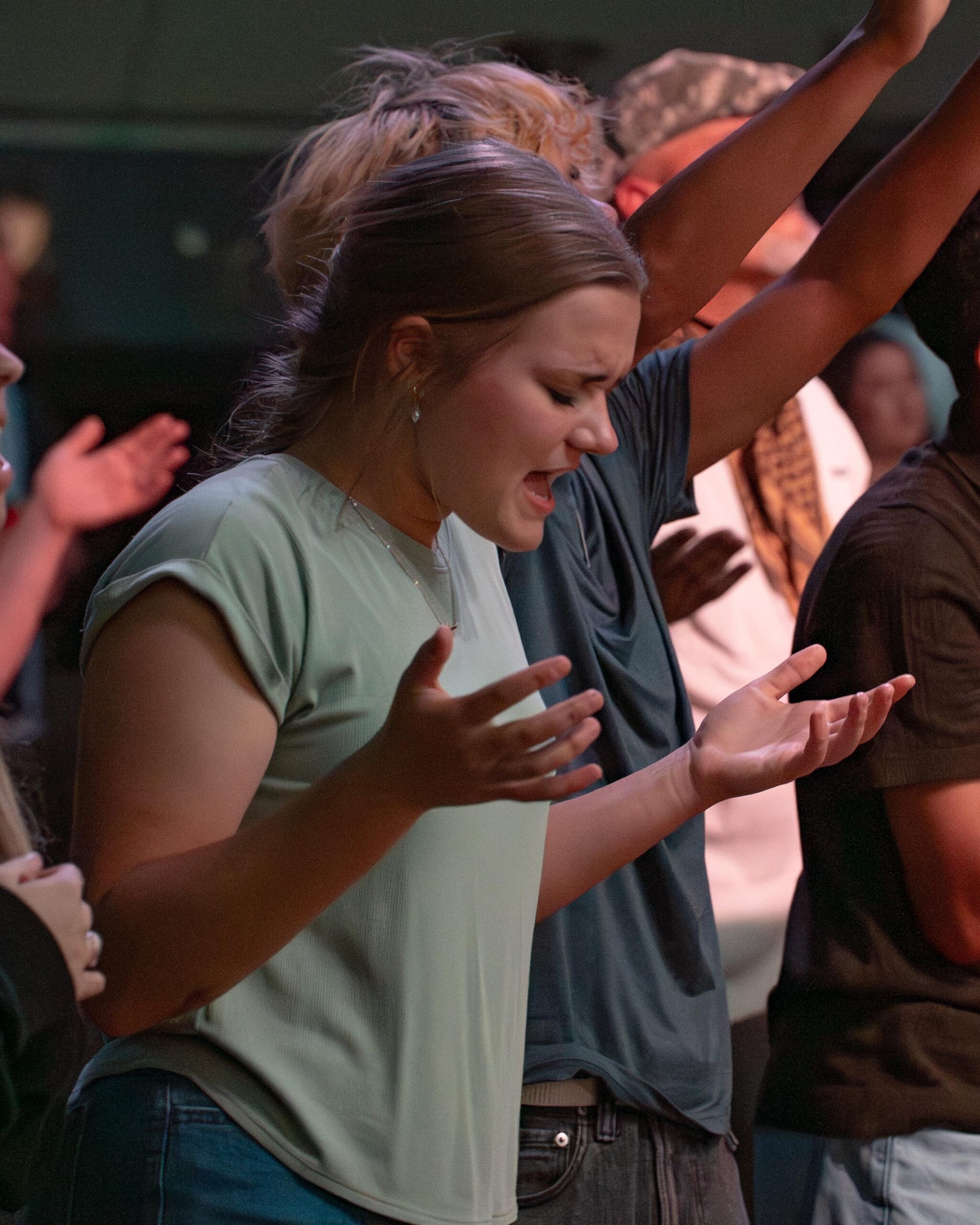 A woman worshipping with her hands raised during a service