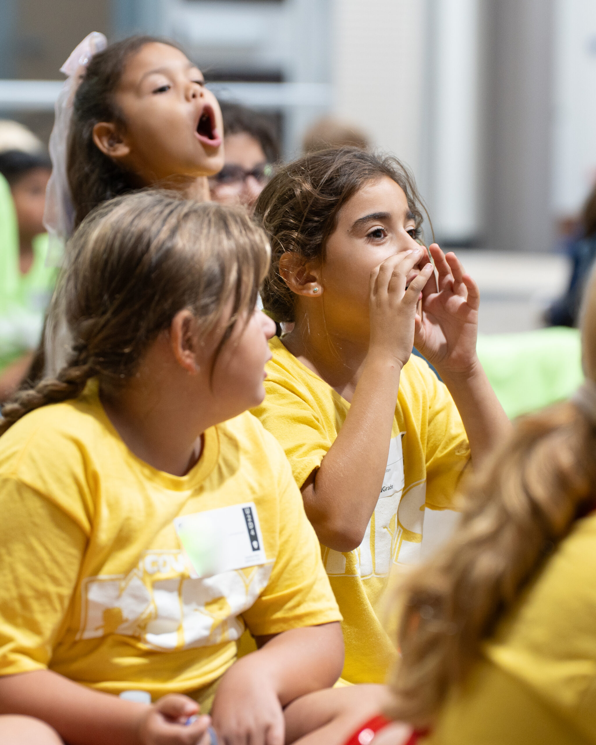 Children singing and cheering together during a Cove Kids gathering