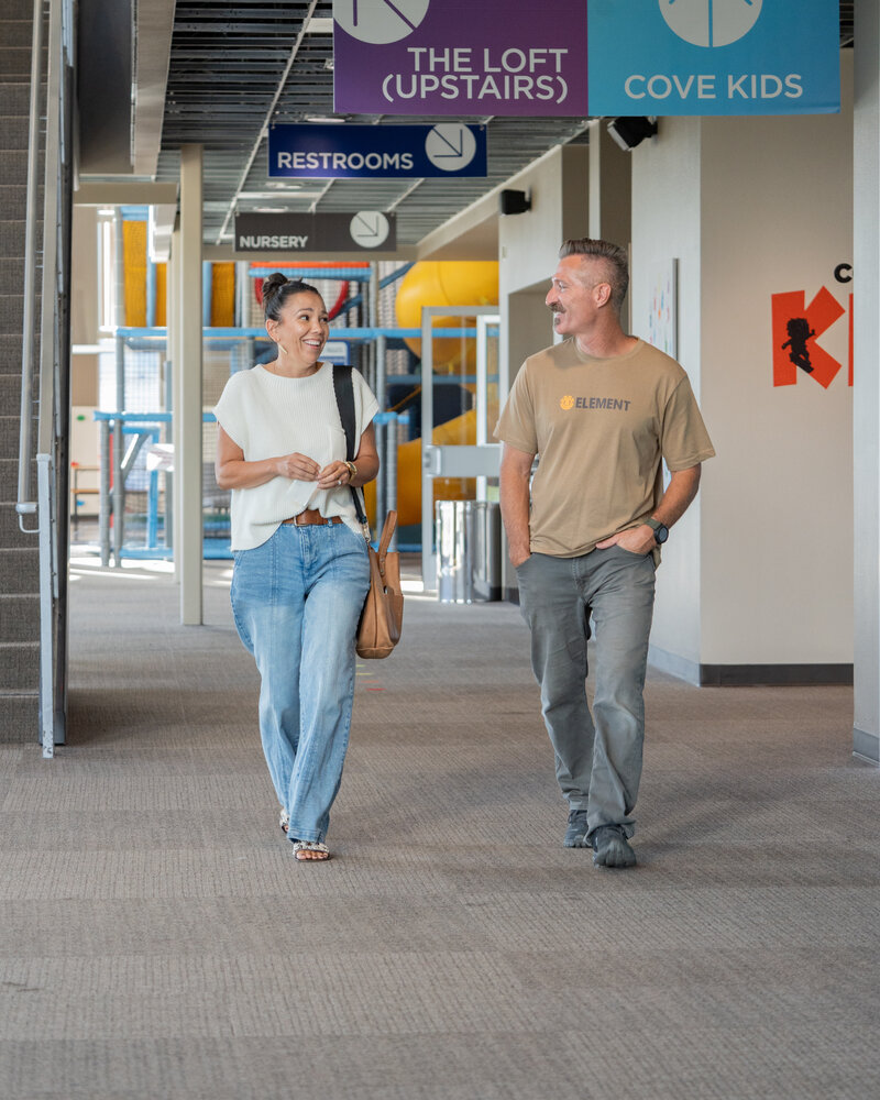 A couple walking together through the church hallway