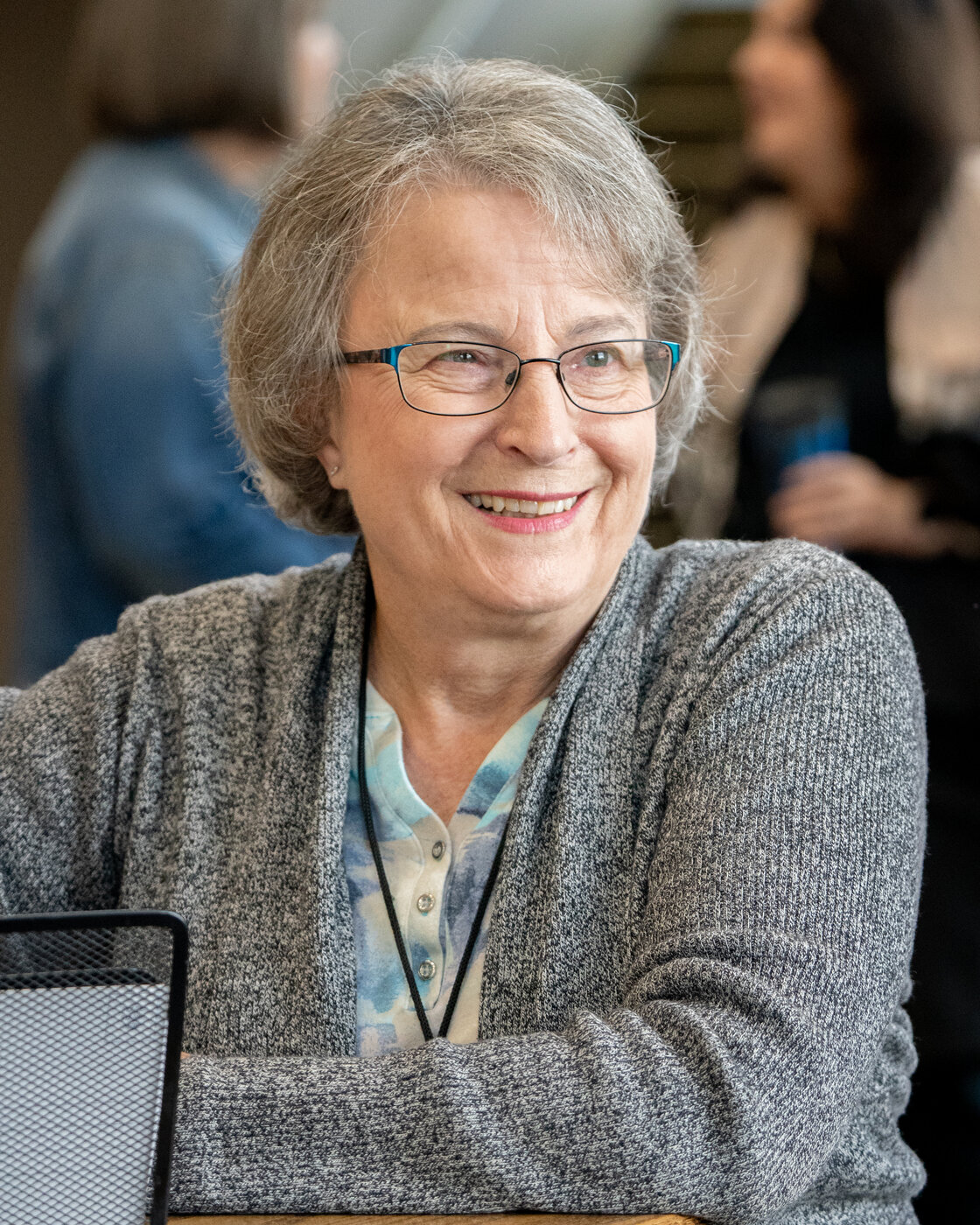 A smiling woman at a Cove Seniors gathering