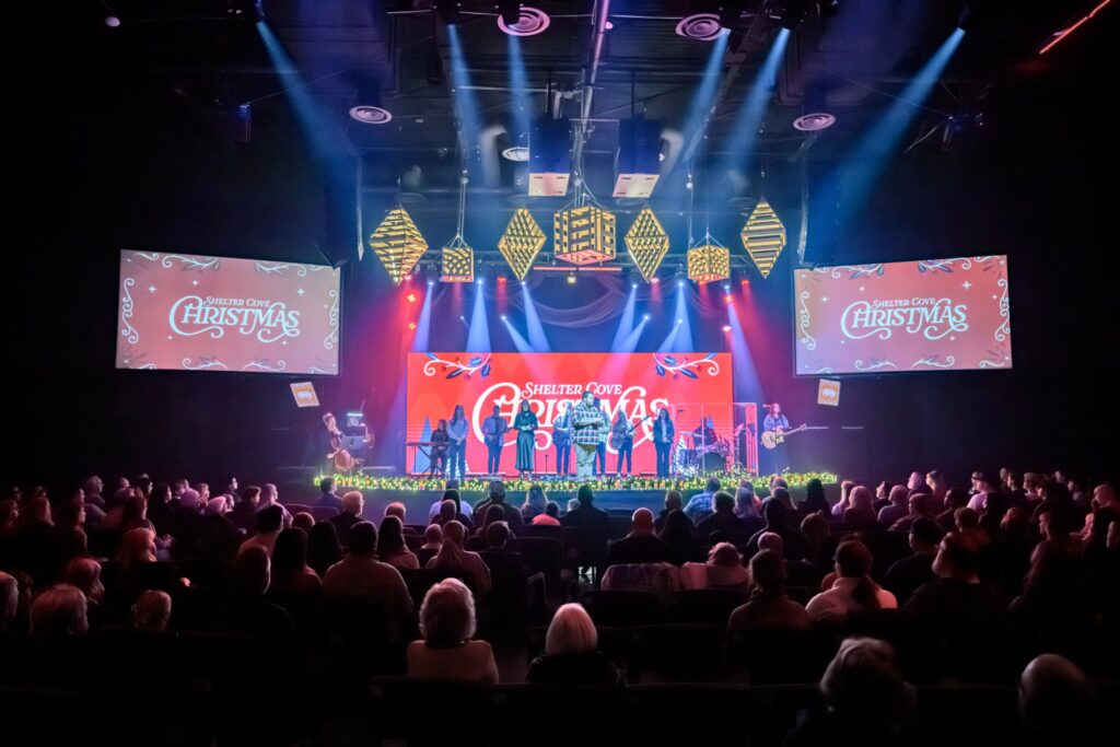 Christmas service at Shelter Cove with the band on stage under the Christmas set and a full congregation